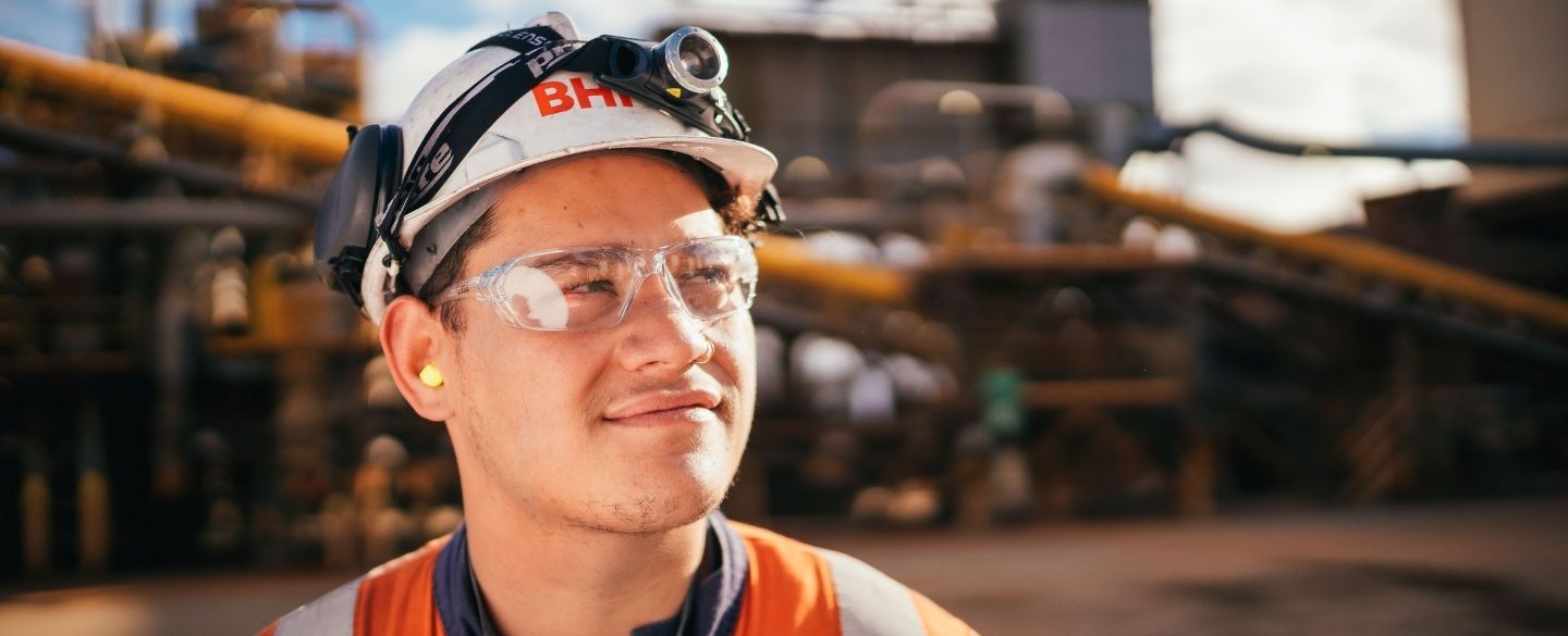 miner on site smiling glasses and helmet