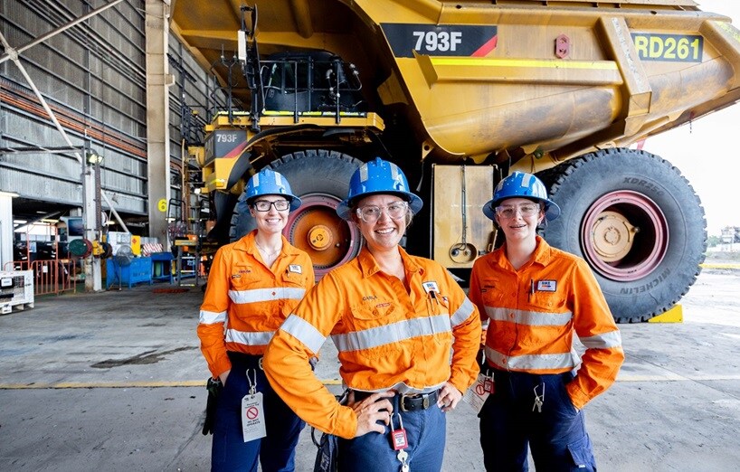Three people smiling in PPE
