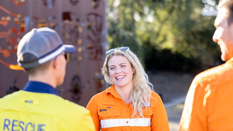 People smiling talking in BHP and BMA shirts