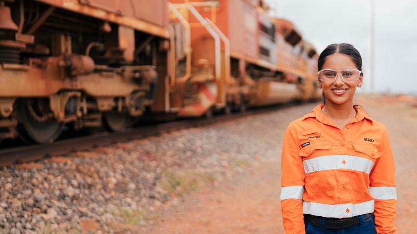 Rail graduate shown at Port Hedland with train in background
