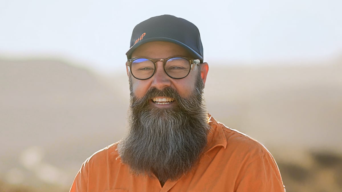 Adrian smiling with landscape in background