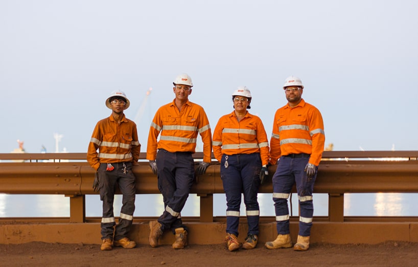 Four workers in orange PPE