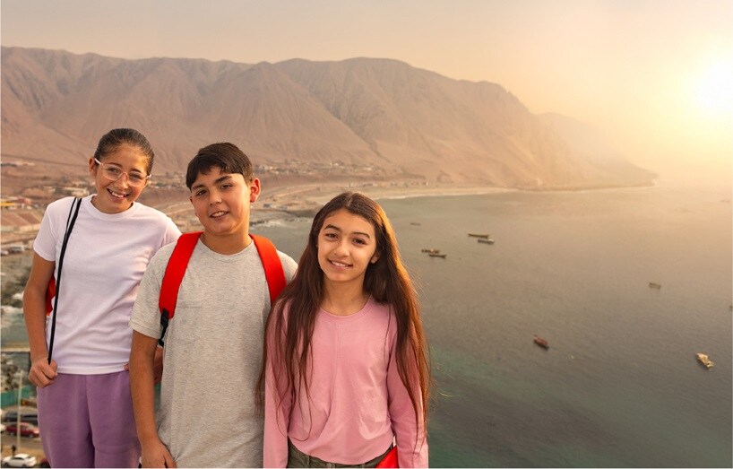 people on cliff edge looking at camera with water behind them