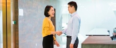 Employees greeting each other