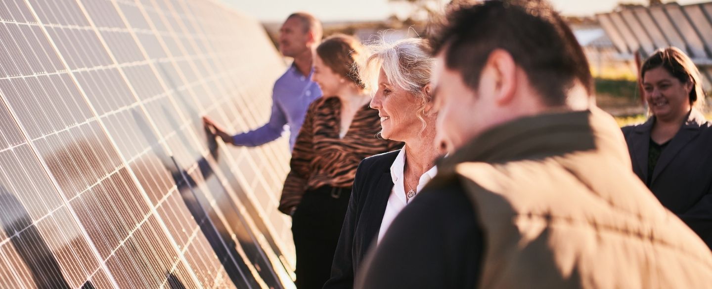 People inspecting a solar panel