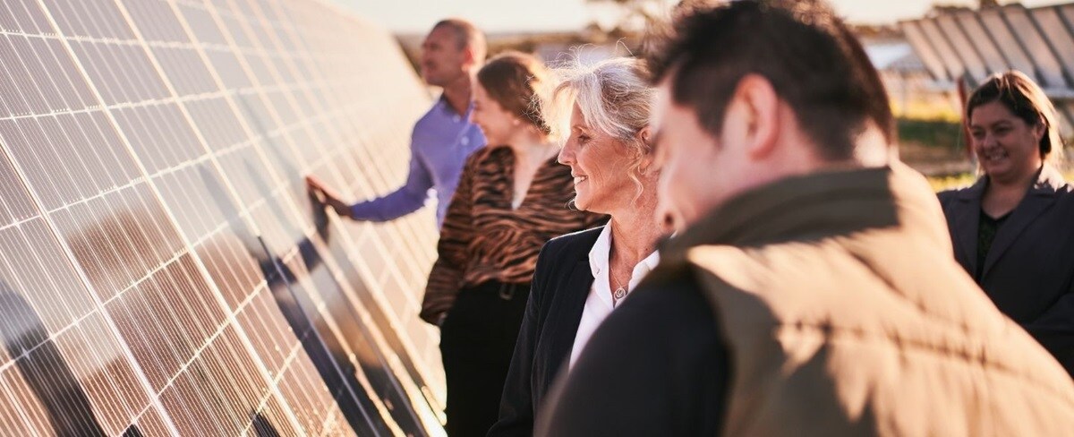 People inspecting a solar panel