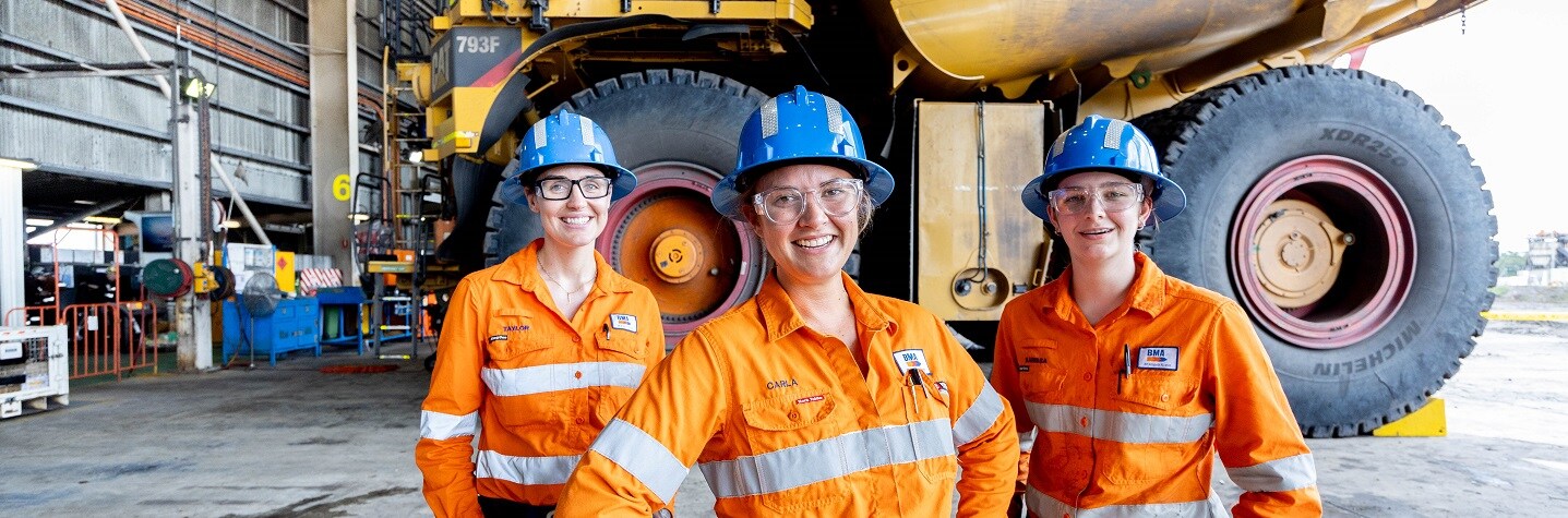 Three people smiling in PPE