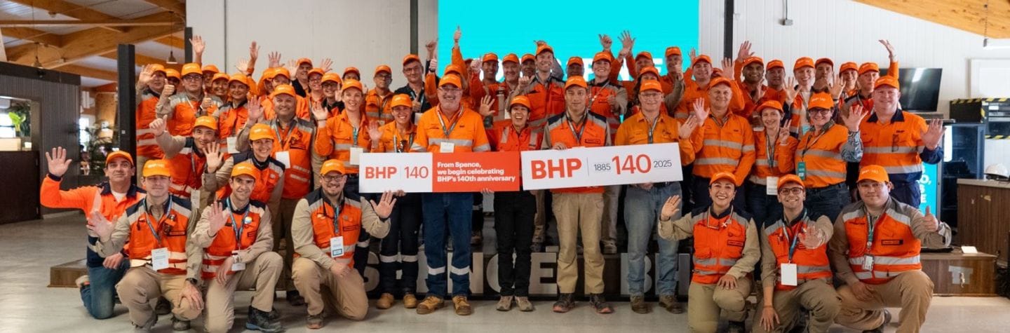 group image of employees holding a 140 sign