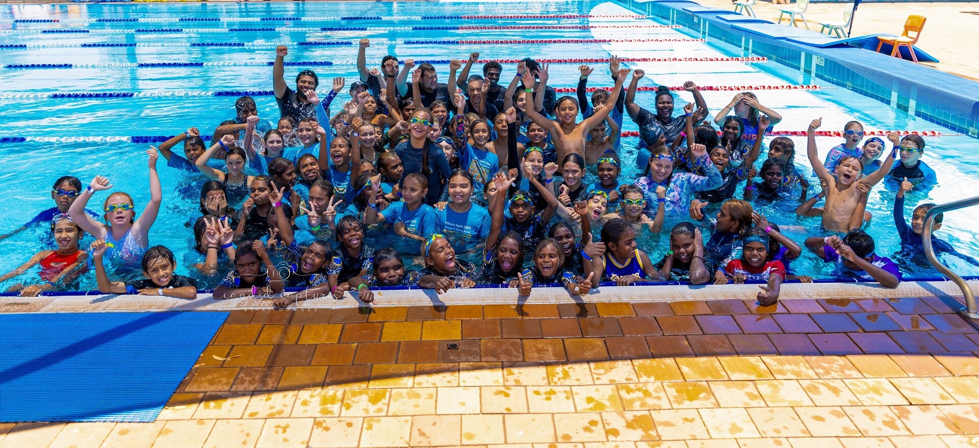 people excited and jumping out of a swimming pool