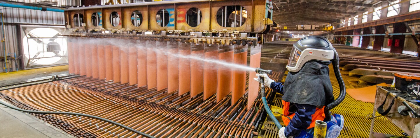 Image of employee in escondida chile spraying copper