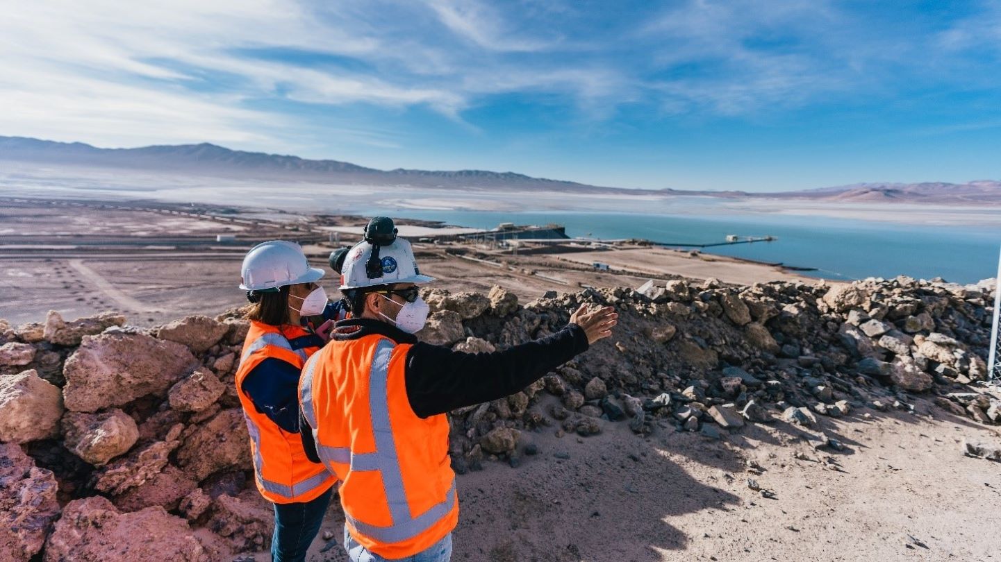 Two people in PPE looking away from the camera