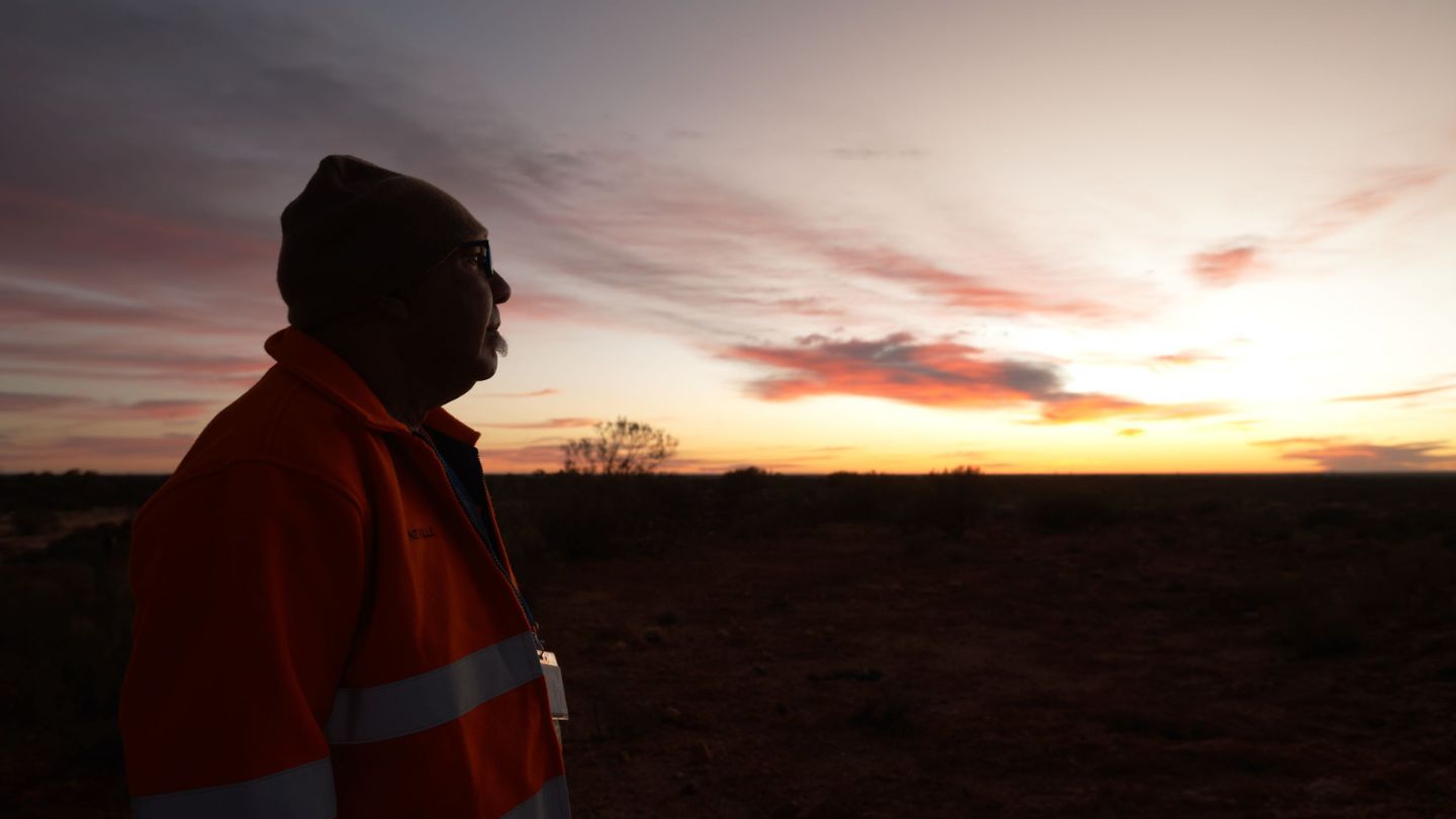 Indigenous man on land at sunset