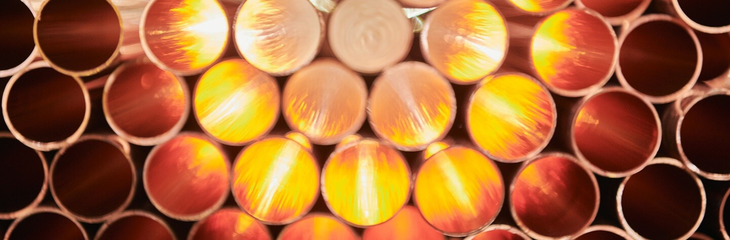 A stack of copper cathodes with the light hitting them.