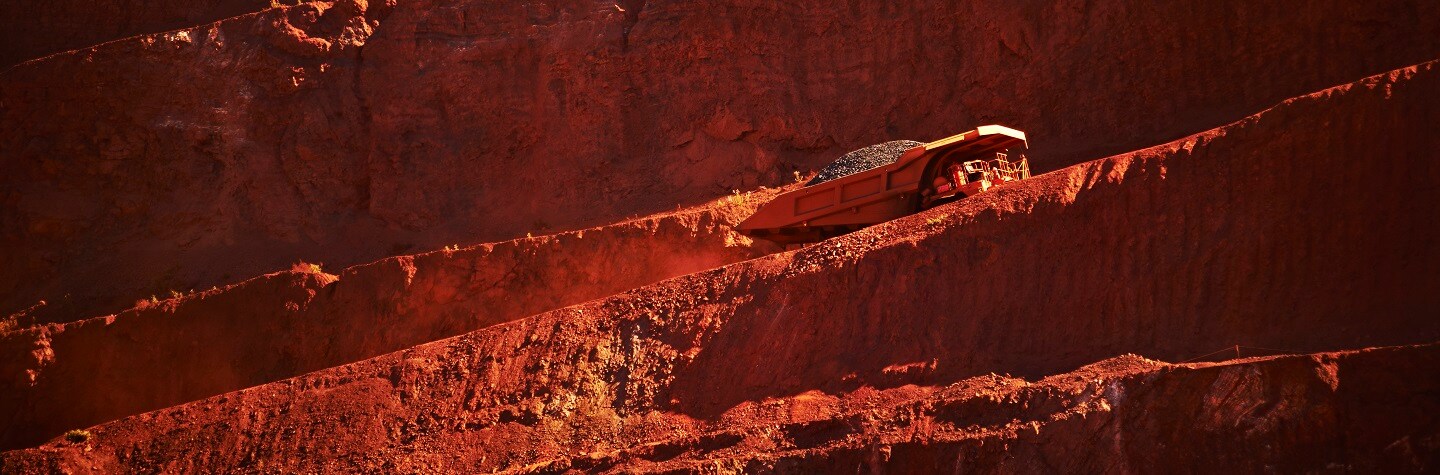 A truck carrying ore drives through the mine. 