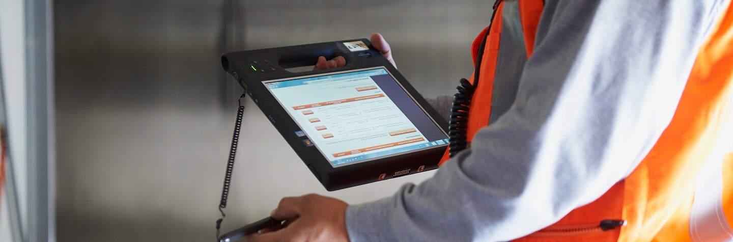 A man holds a tablet. 