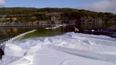 whitetarpbeinghauledintowatercatchment 2021