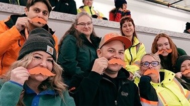 People holding orange moustaches