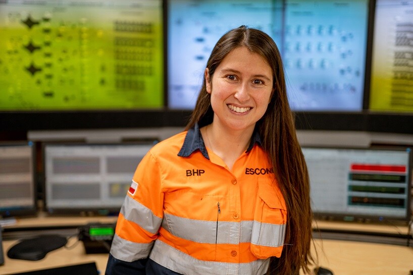 Worker in front of screens