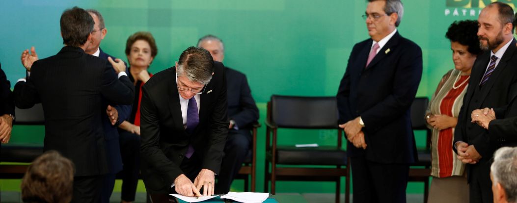 people signing at a signing ceremony