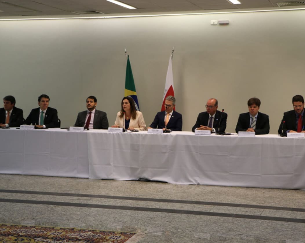 people at a table signing documents