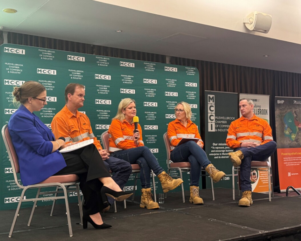 Panel of BHP leadership on stage providing updates at Business Chamber meeting