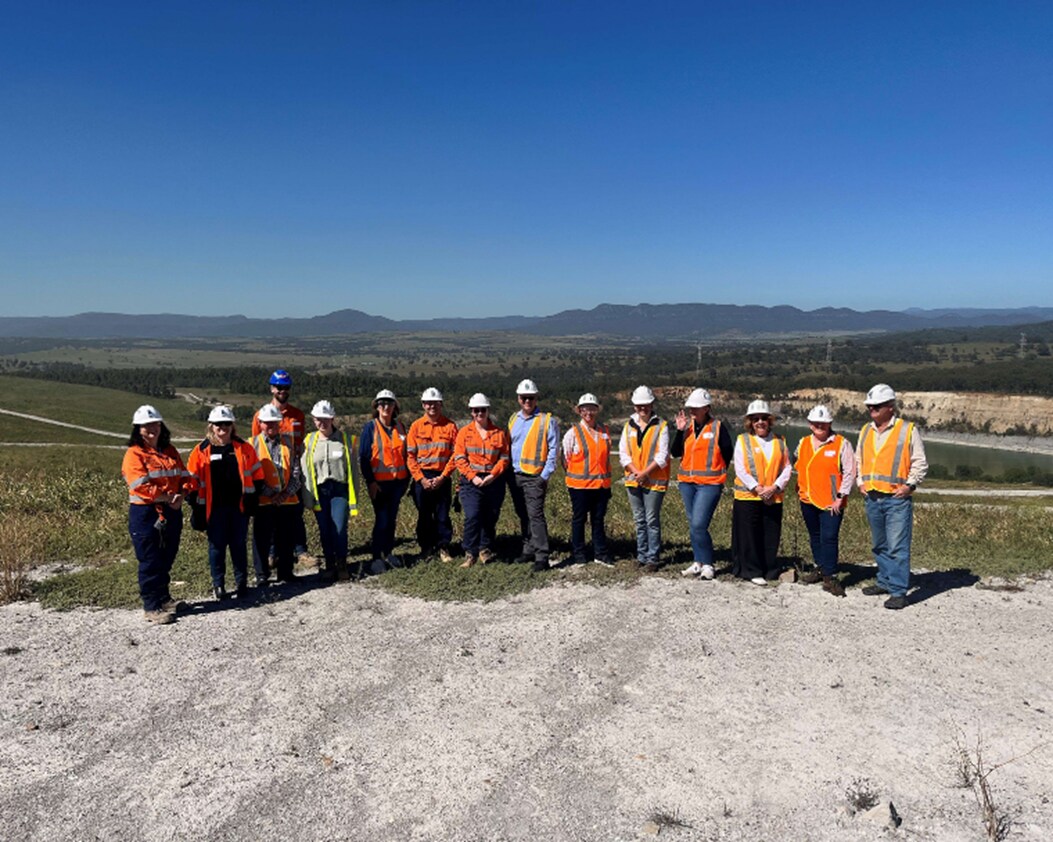 Image of people standing at look out at Mt Arthur Coal