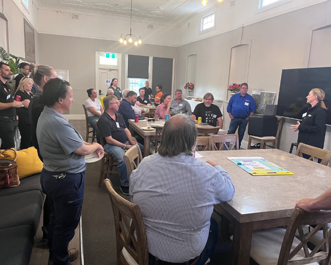 People gathered in a room for community discussion event 