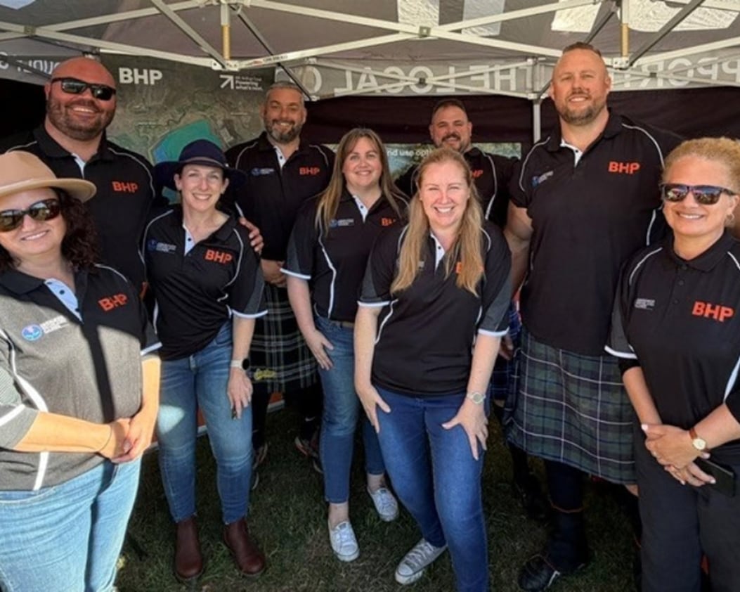 Mt Arthur Coal teammates standing at Aberdeen Highland Games stall