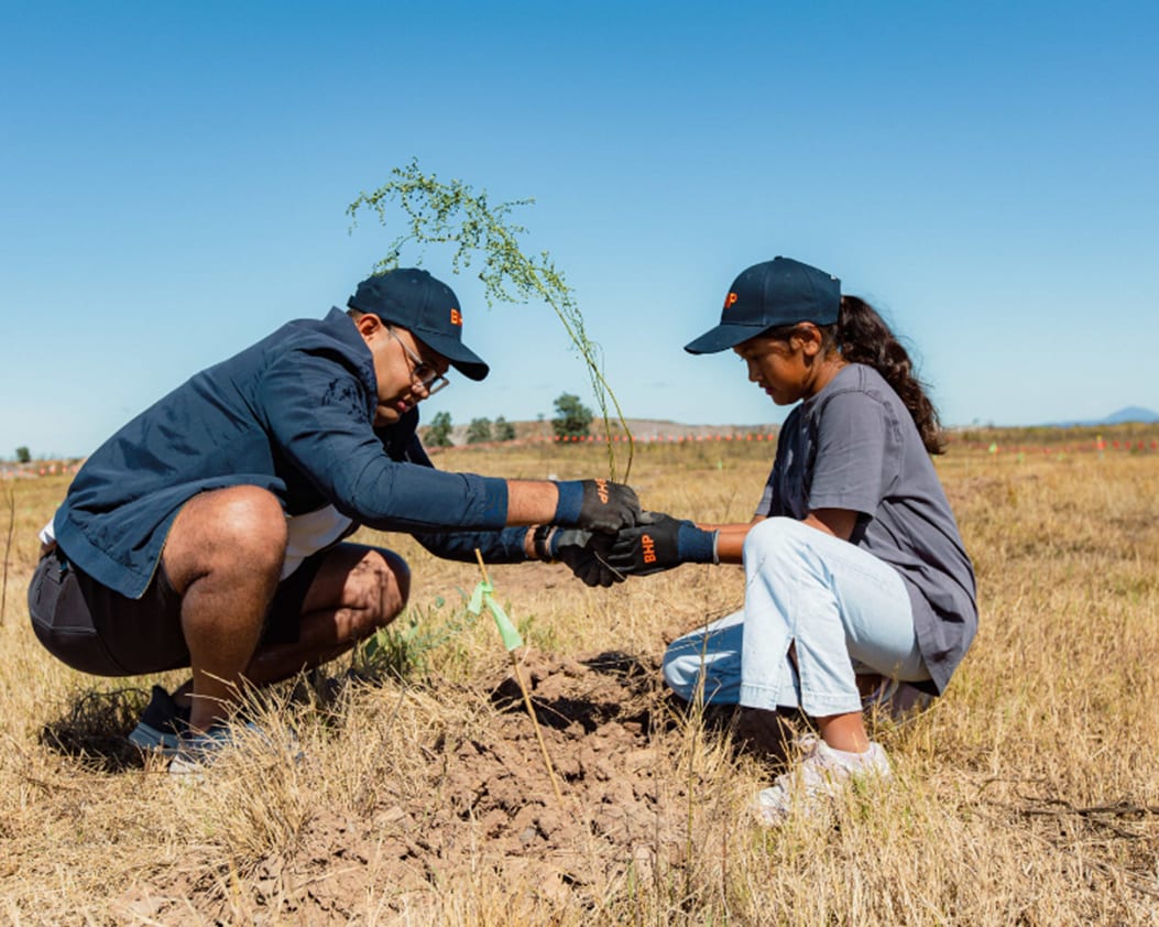 Image of people planting tree at Mt Arthur Coal Community Tree Planting Day 2026