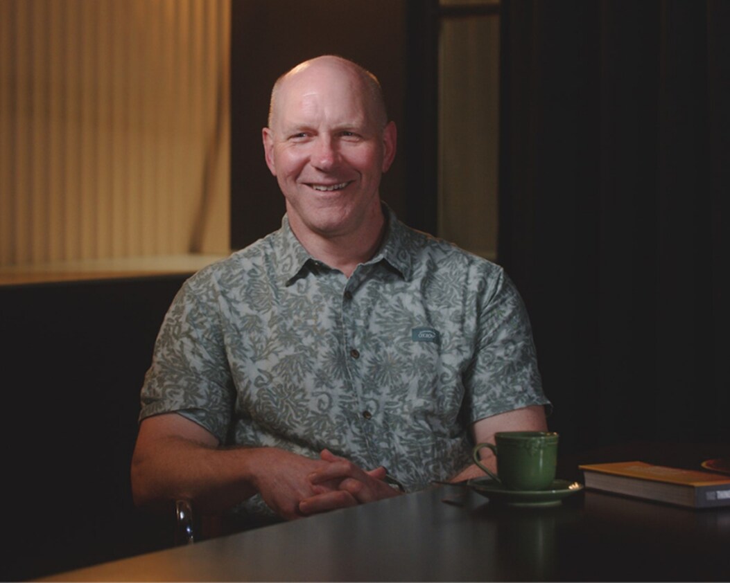 Image of Dr Pete Whitbred-Abrutat sitting at a table
