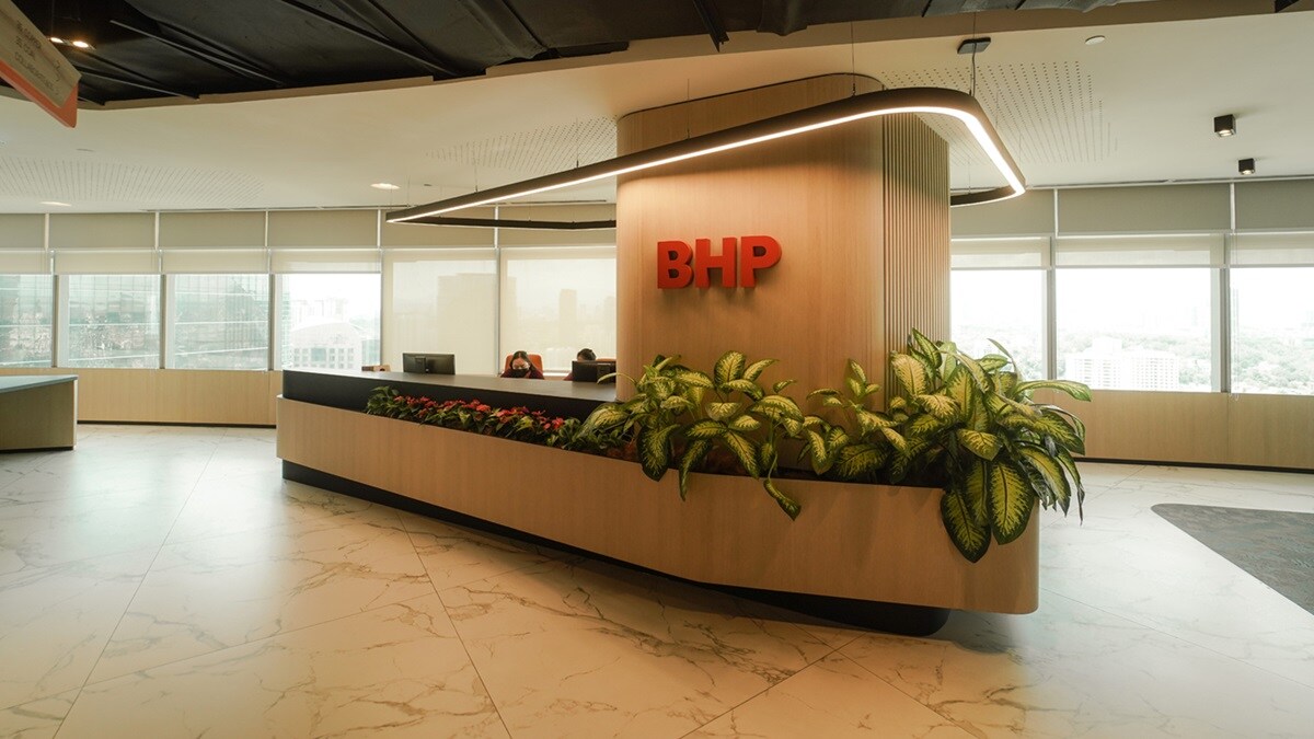 Two women laughing at work table in BHP office