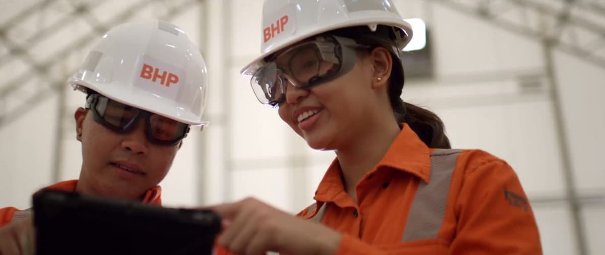 two people looking at a computer screen and smiling