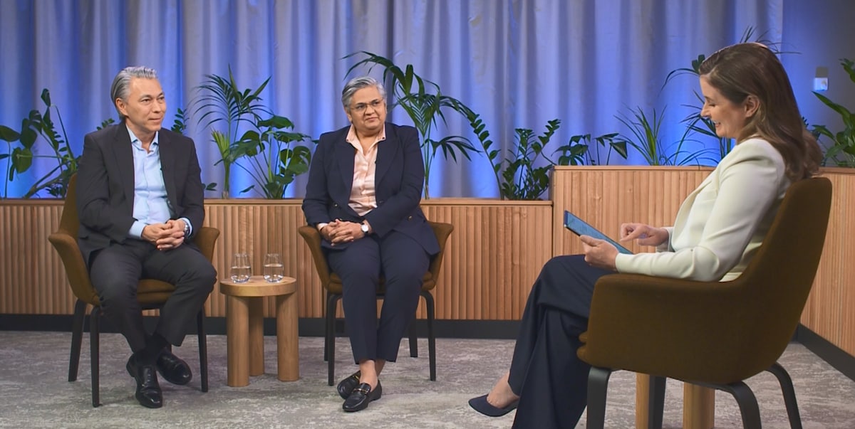 3 people sitting in a circle answering questions from an ipad