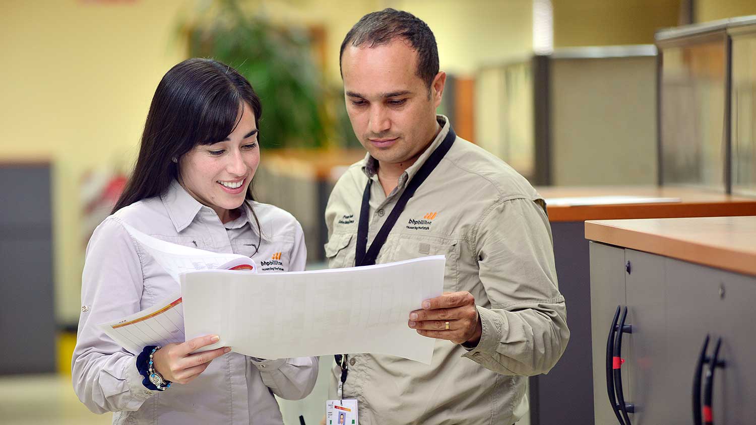 Two employees reading document