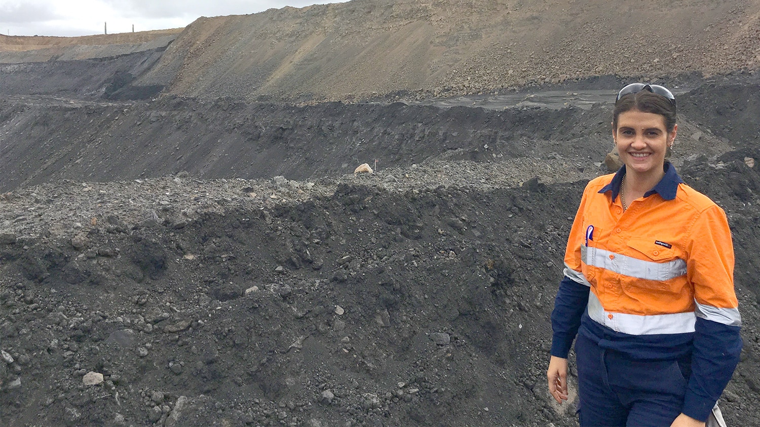 Lydia standing in front of some coal