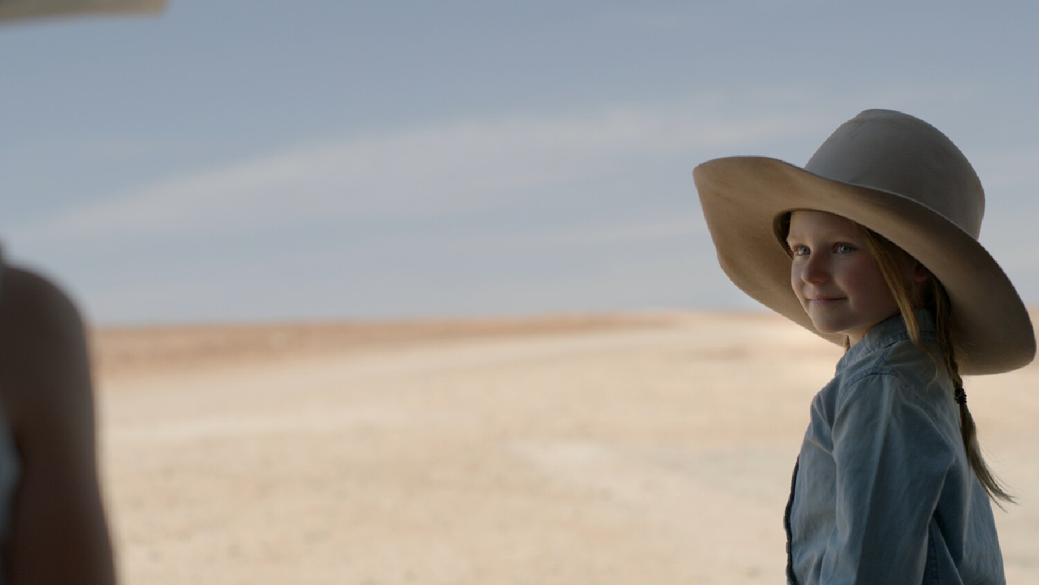Child in a hat in the desert