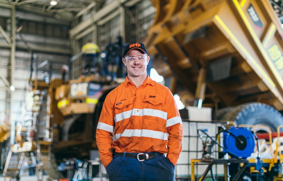smiling man in orange high vis