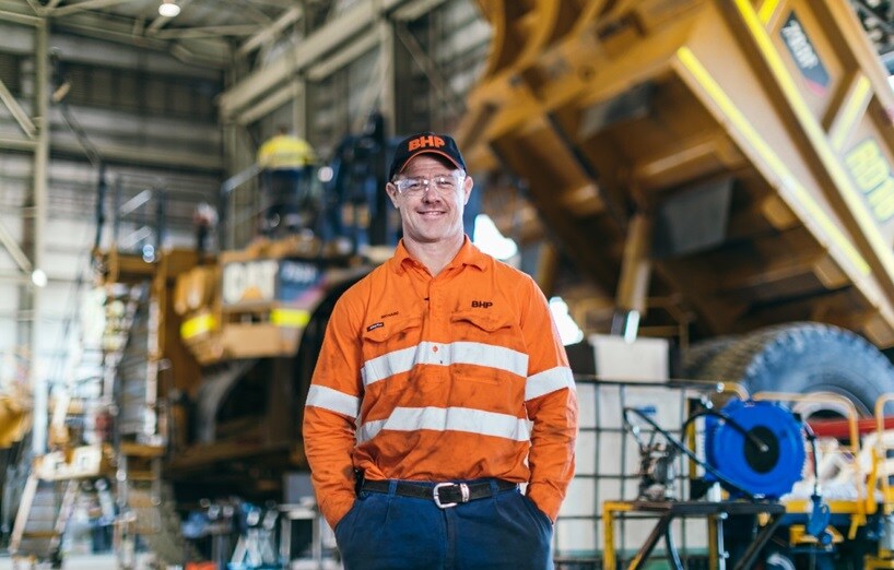 smiling man in orange high vis