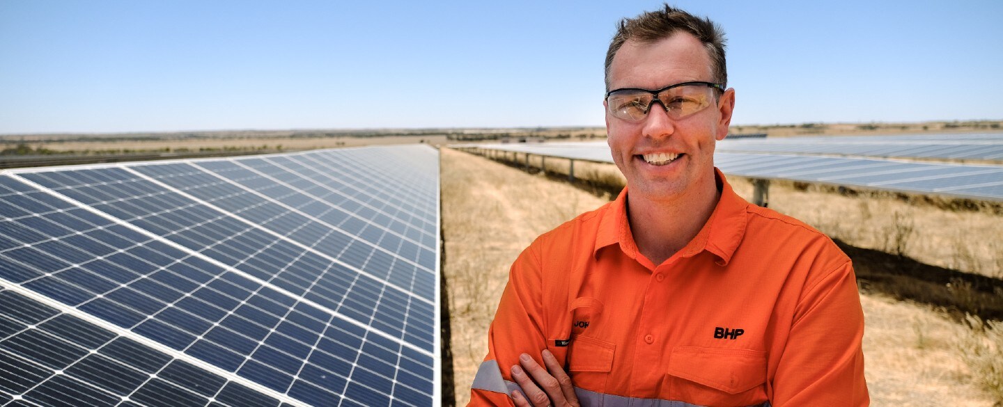 Man in front of solar panels
