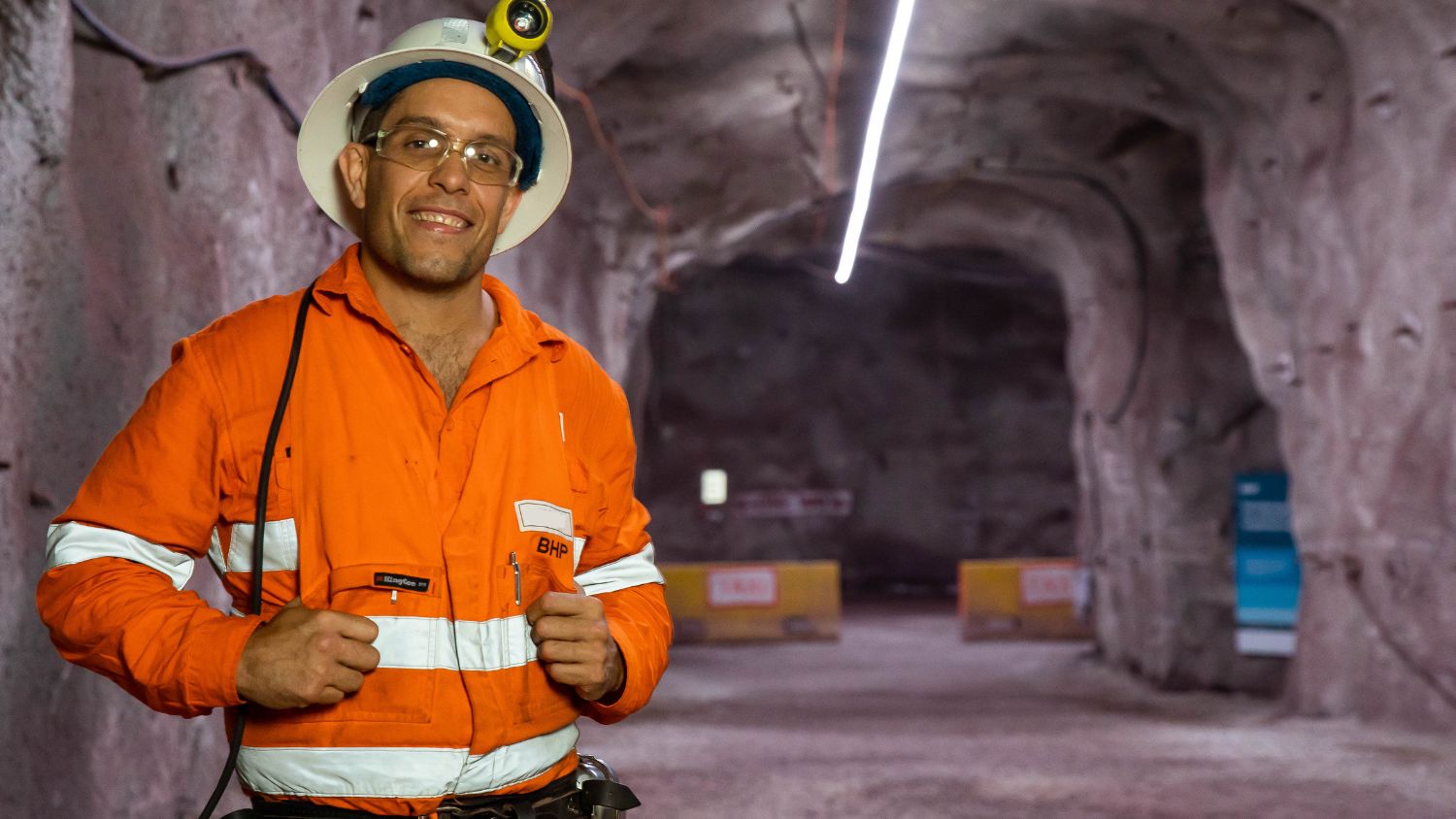 miner on site smiling glasses and helmet