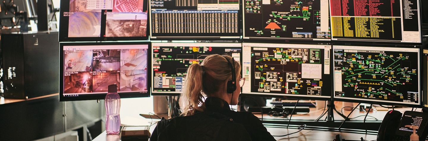 Person working in front of computer screens