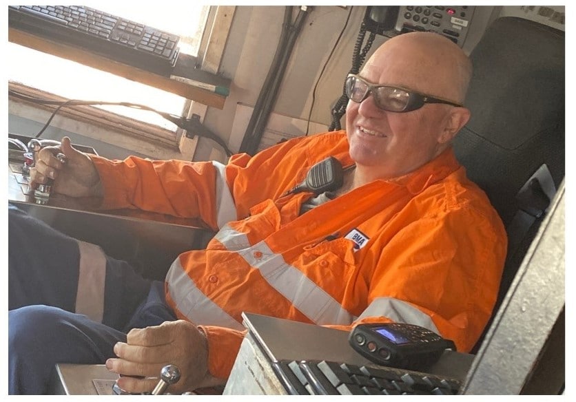 man in mining uniform in a digger
