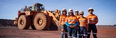 Team in front of dozer