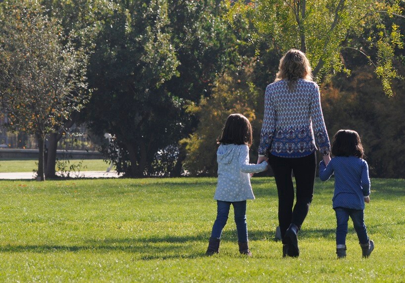 Woman and children holding hands