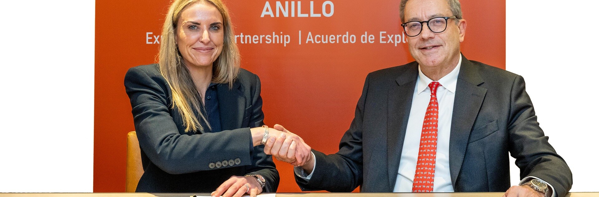 People shaking hands whilst signing