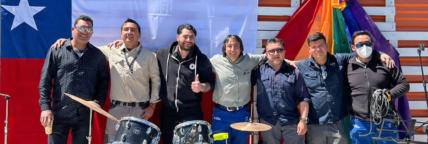 band of musicians arm in arm at a gig