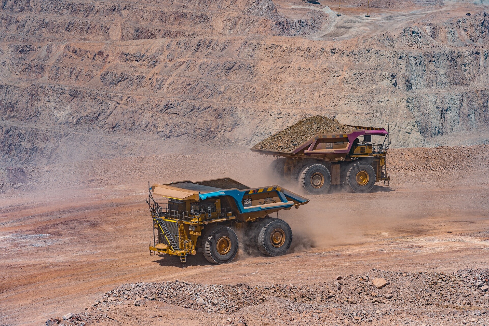 image of two trucks at a mining site in chile