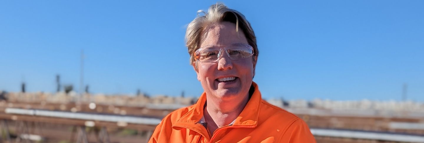woman in mining shirt smiling to camera at Olympic Dam mine site