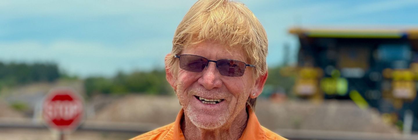 man smiling at a mine site